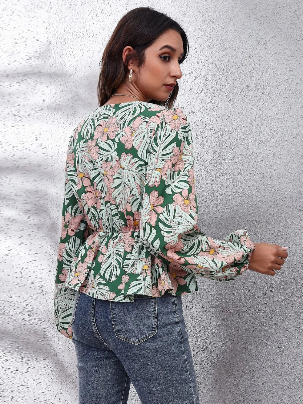 Floral peplum blouse side view on model