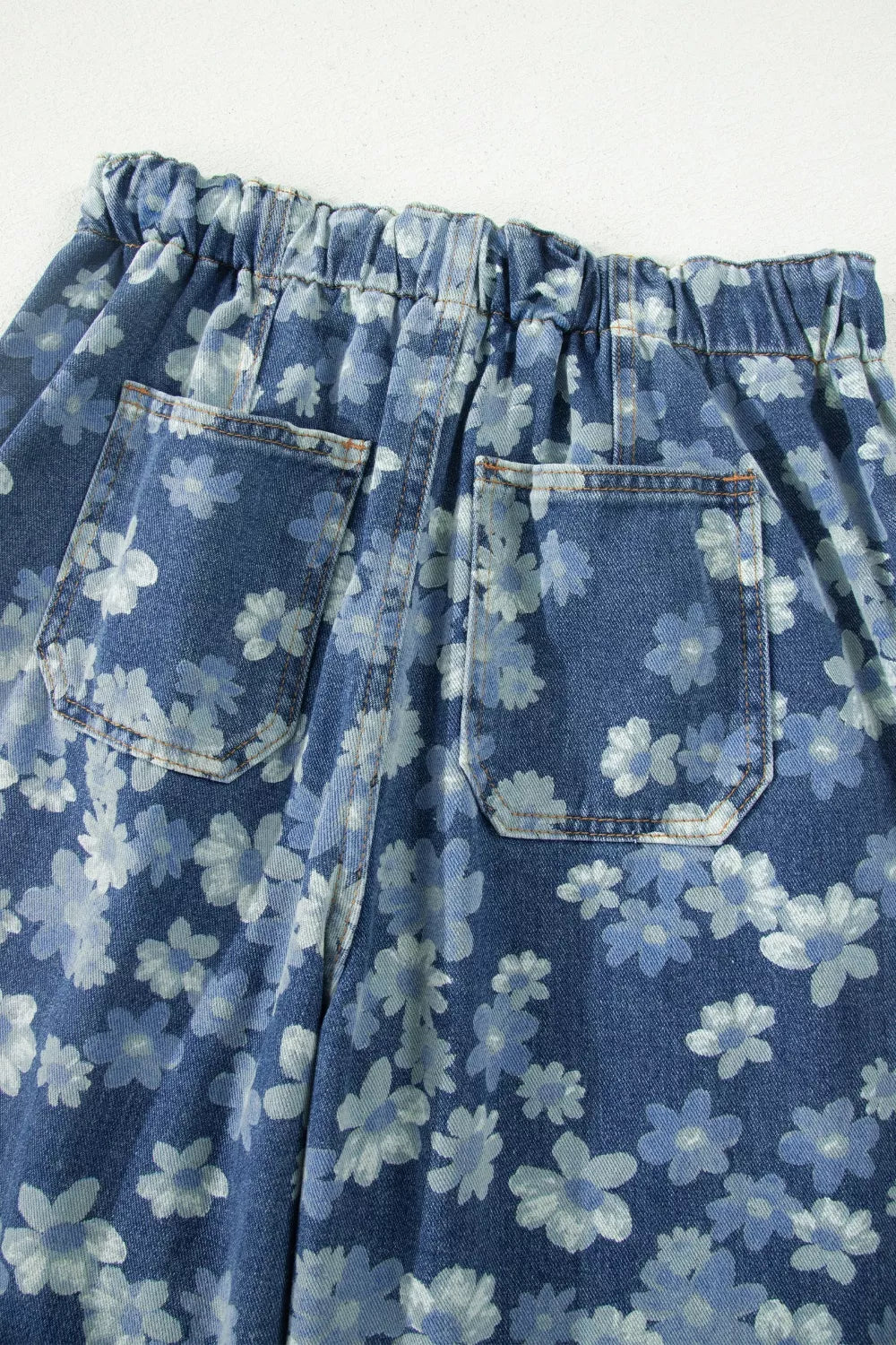 Dusty blue floral denim fabric close up