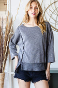 Boat neck exposed seam slit top in vintage black, front view