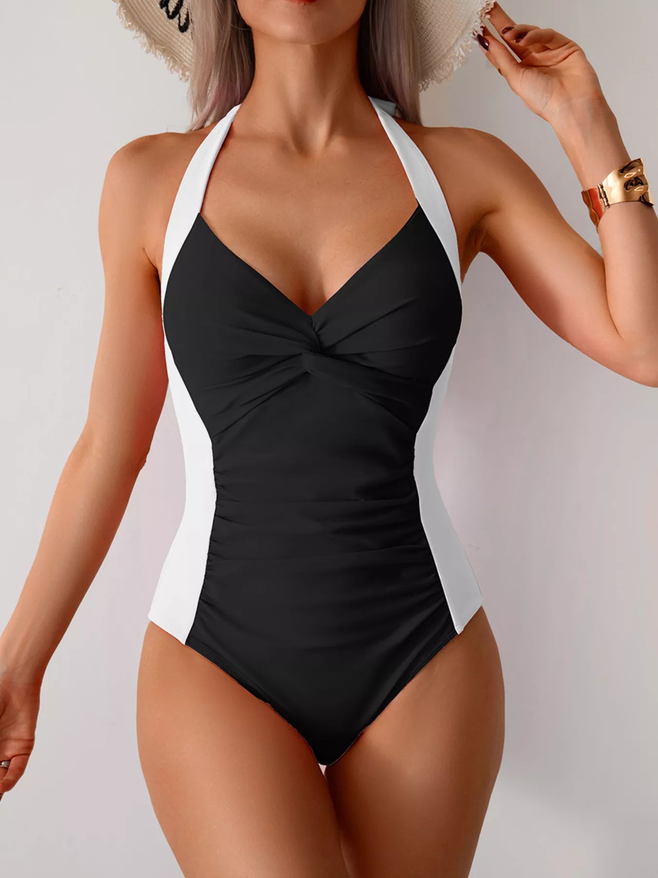 Ruched halter swimsuit worn on beach