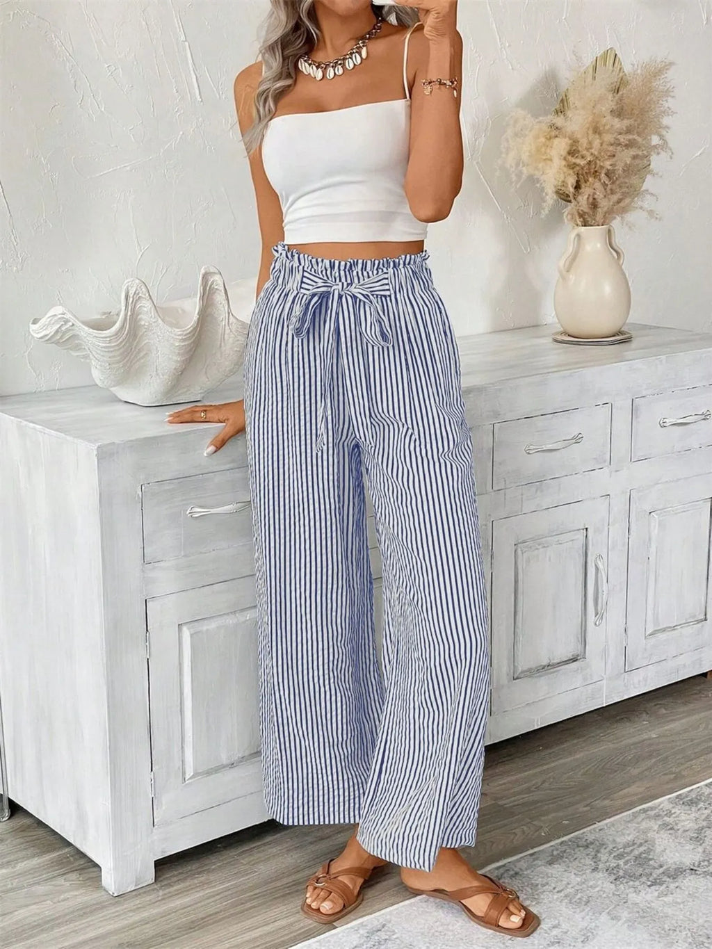 Blue paper bag pants side view on model