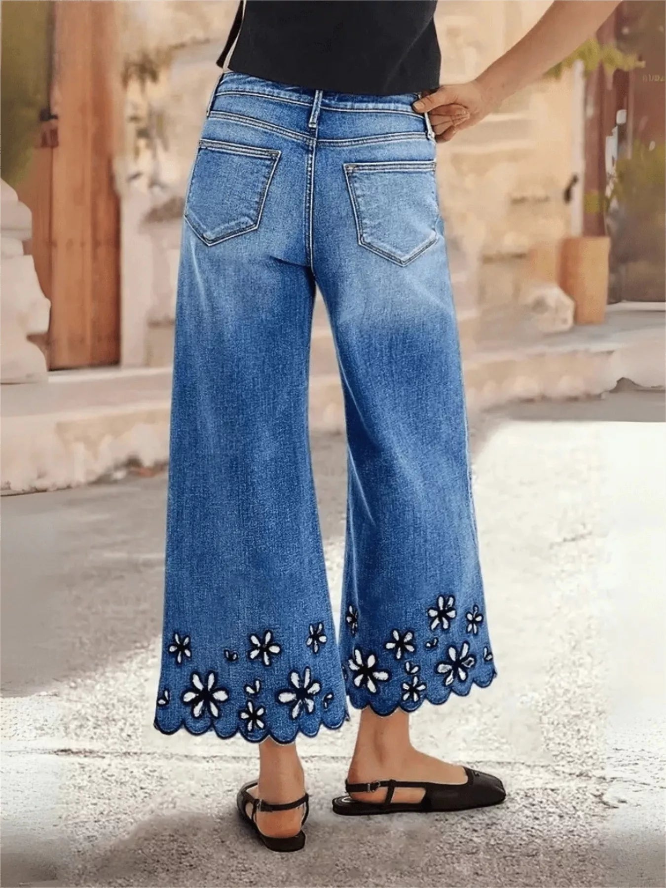Embroidered cropped jeans back view with wide leg cut