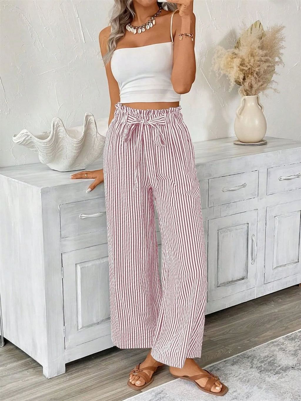 Dusty pink paper bag pants side view on model
