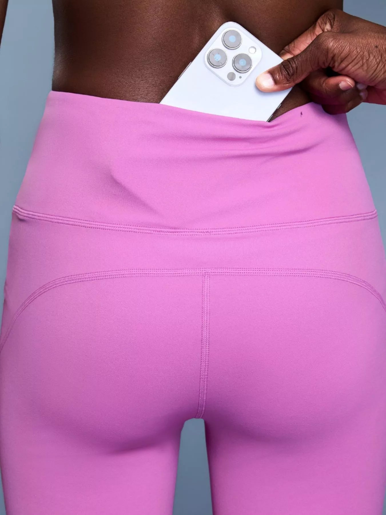 Model posing in high waisted flare active pants