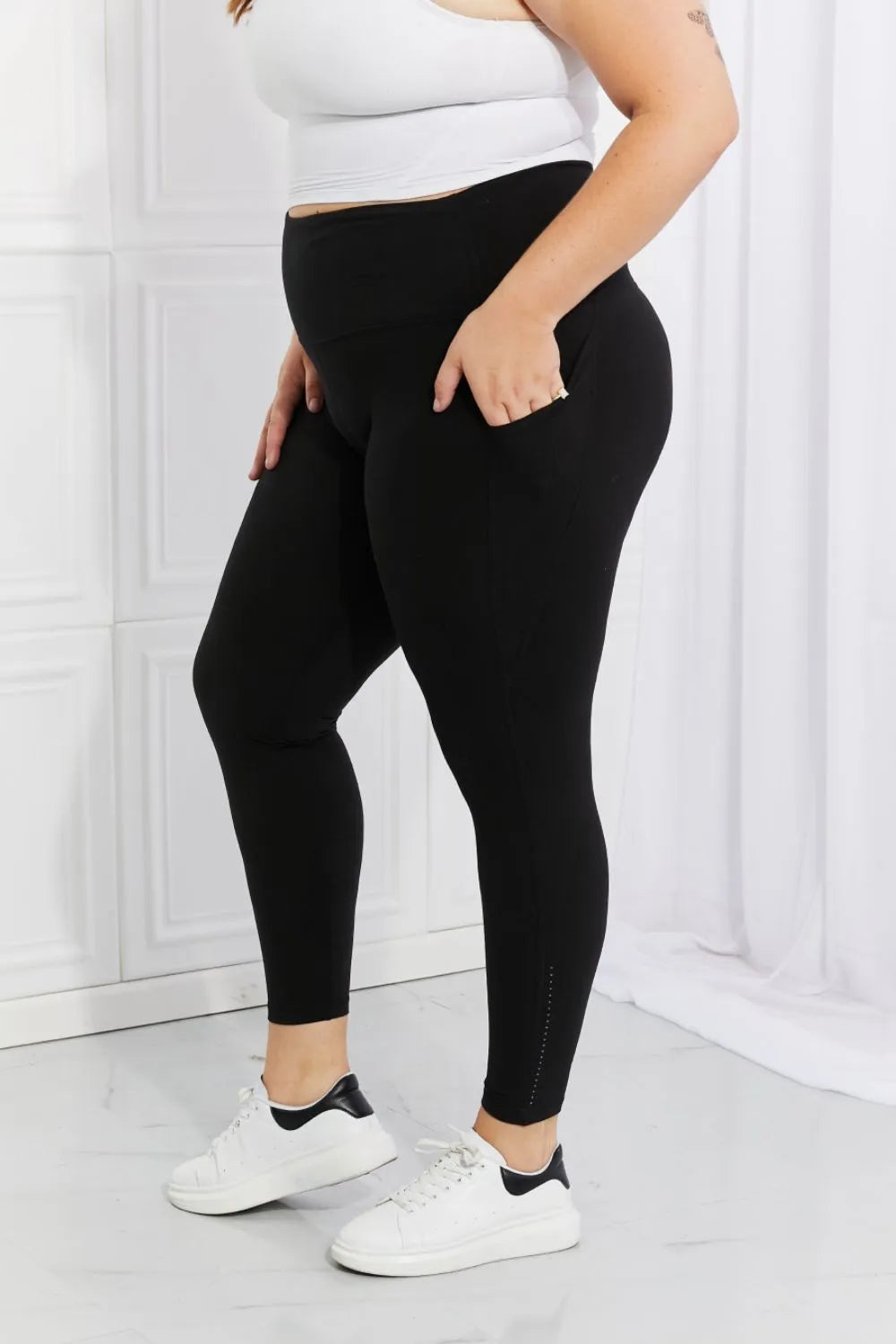 Model styled in black active leggings