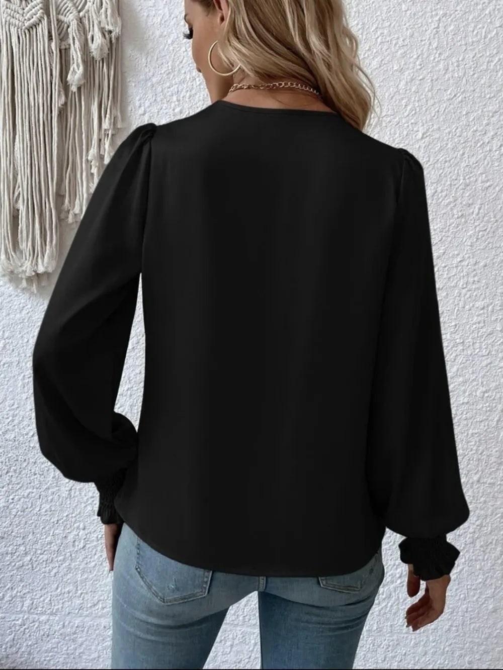 Model wearing surplice smocked blouse