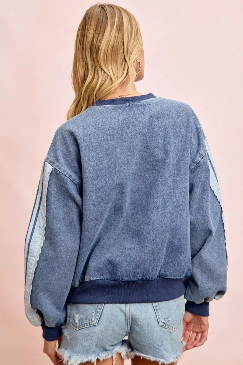 Washed denim sweatshirt back view on model