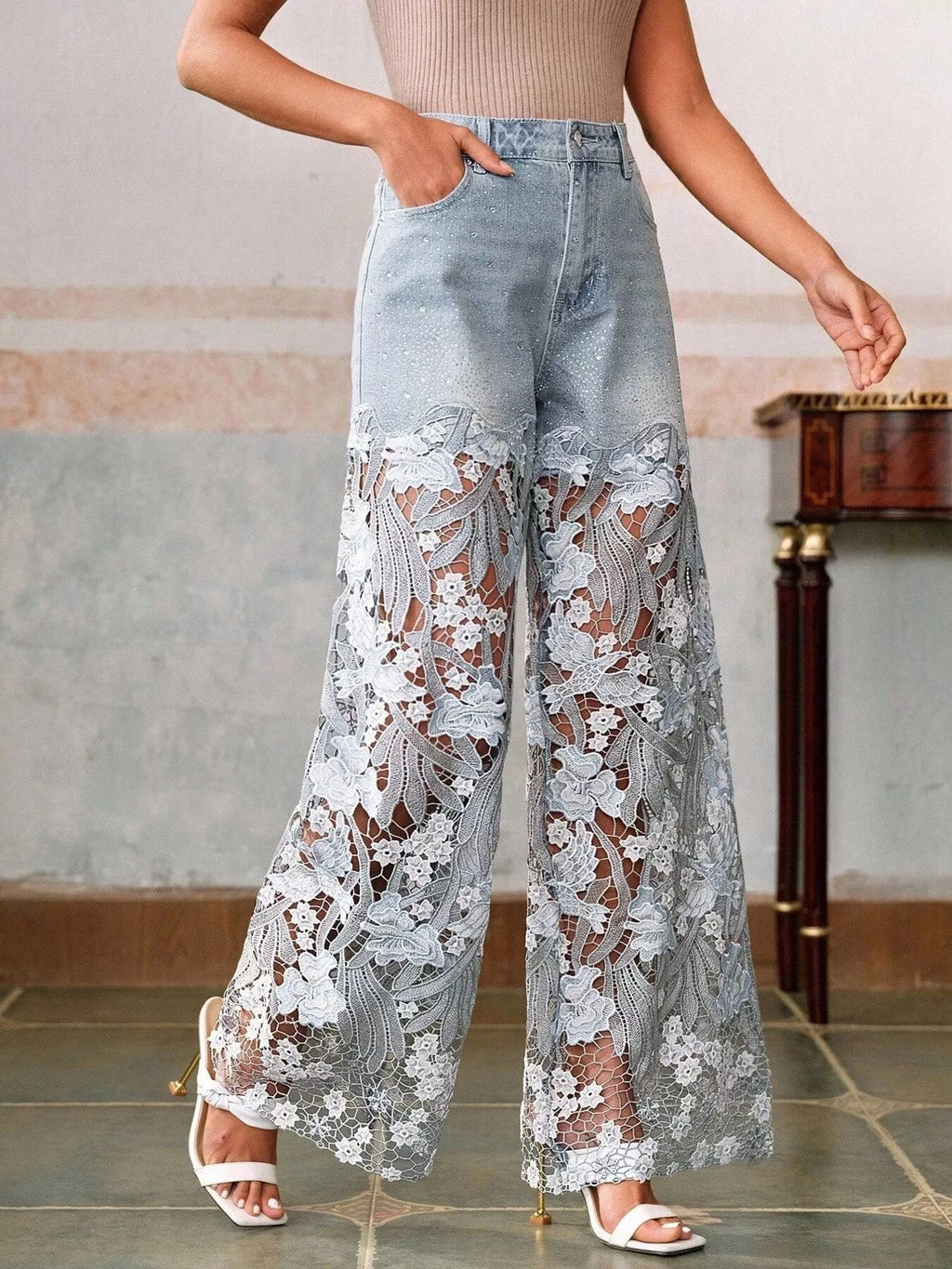 Lace detail close up on light blue jeans