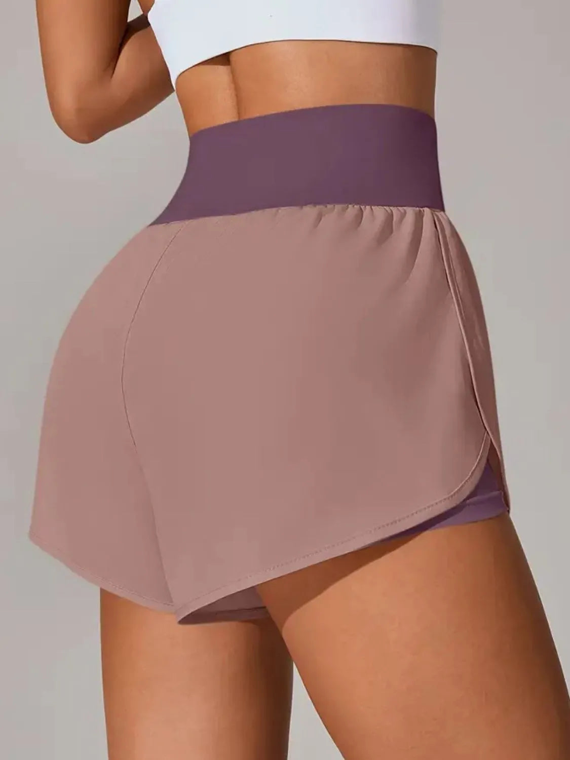 White pocketed active shorts styled for the gym