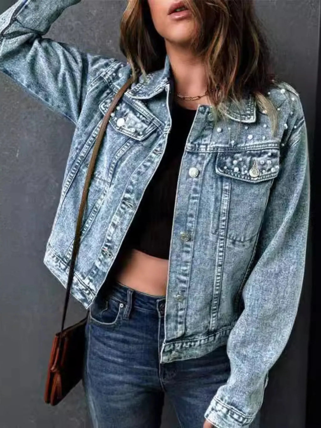 Model wearing plus size pearl detail denim jacket styled with jeans