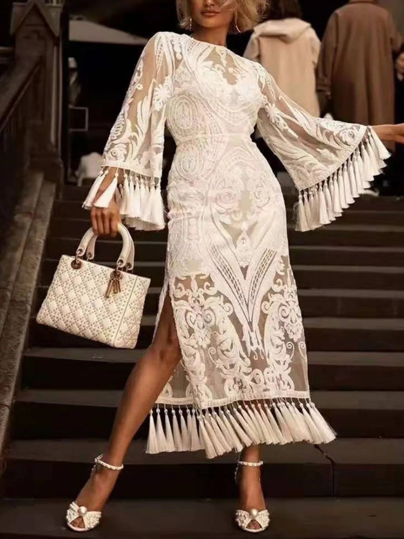 Tassel hem detail on white boho lace dress