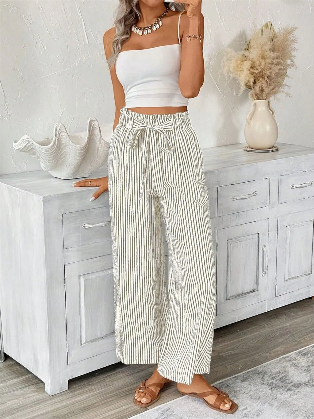 Khaki paper bag pants detail of high rise waist