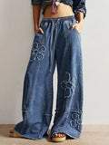 Raw hem and distressed detail on floral jeans