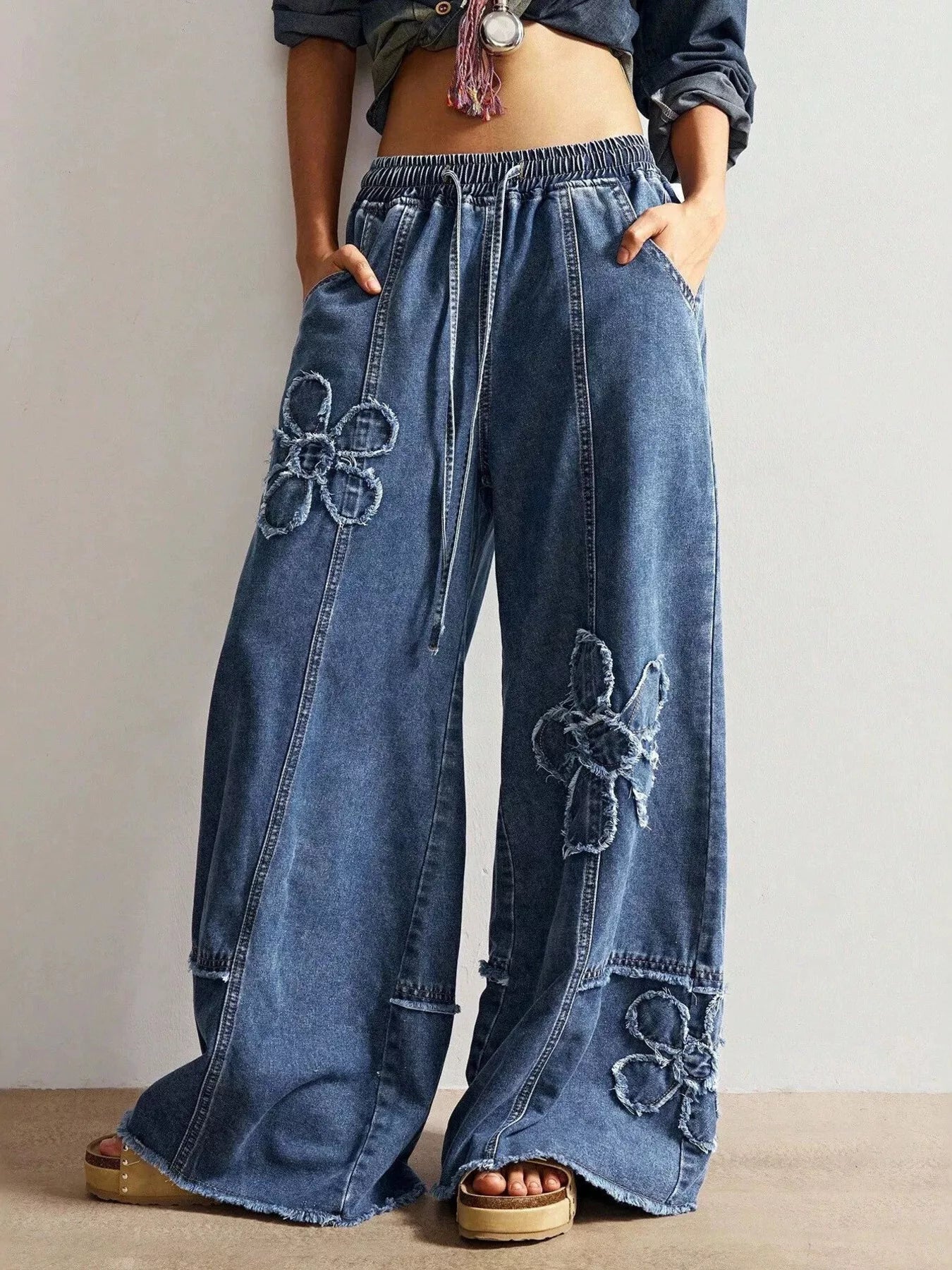 Raw hem and distressed detail on floral jeans