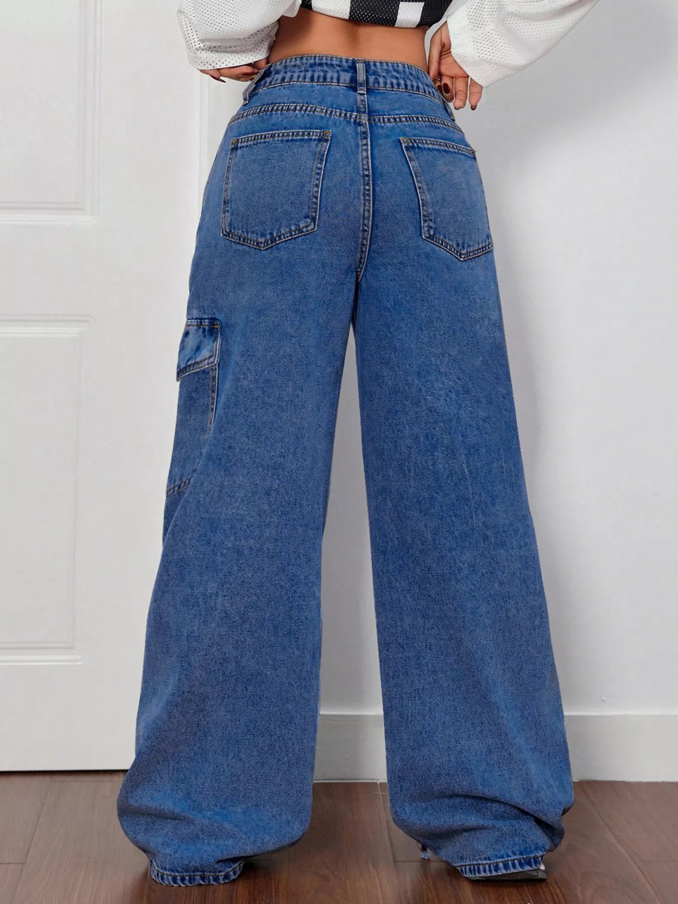 Woman wearing bow tie accent wide leg jeans
