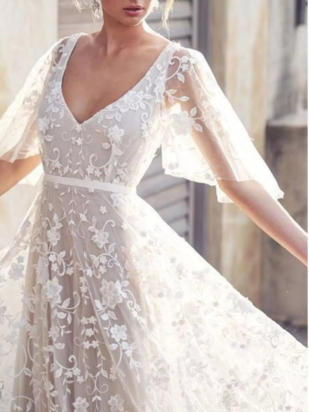 Flutter sleeve detail on white lace dress