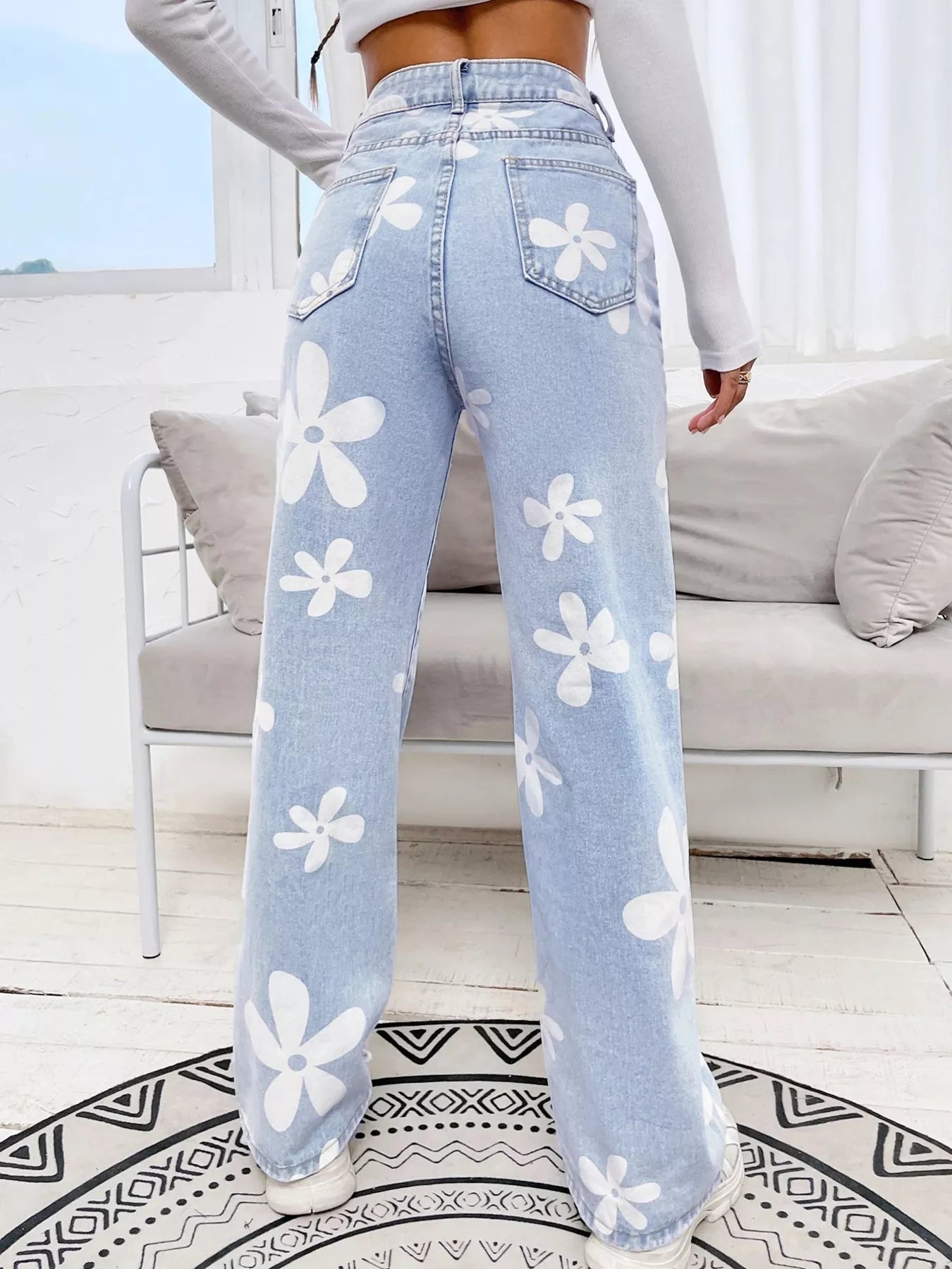 Black floral jeans side view with wide leg silhouette