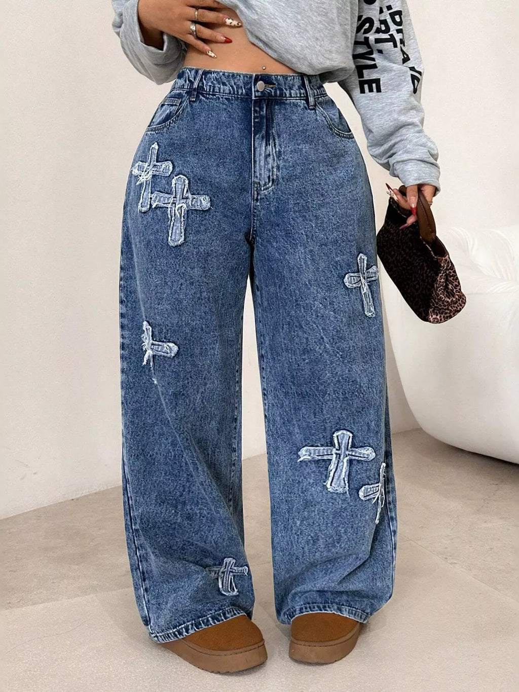 Cross applique detail on dark blue washed denim