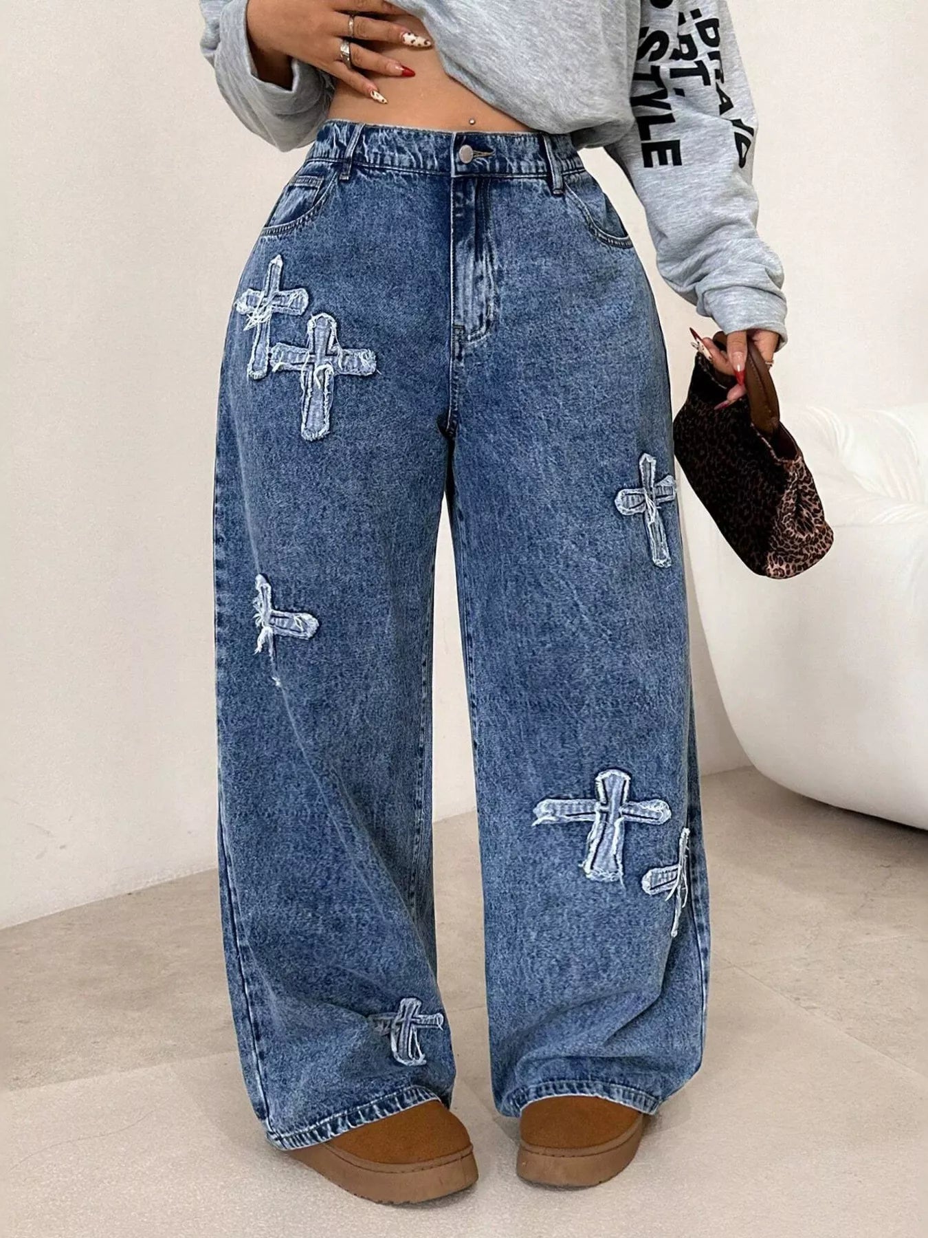 Cross applique detail on dark blue washed denim