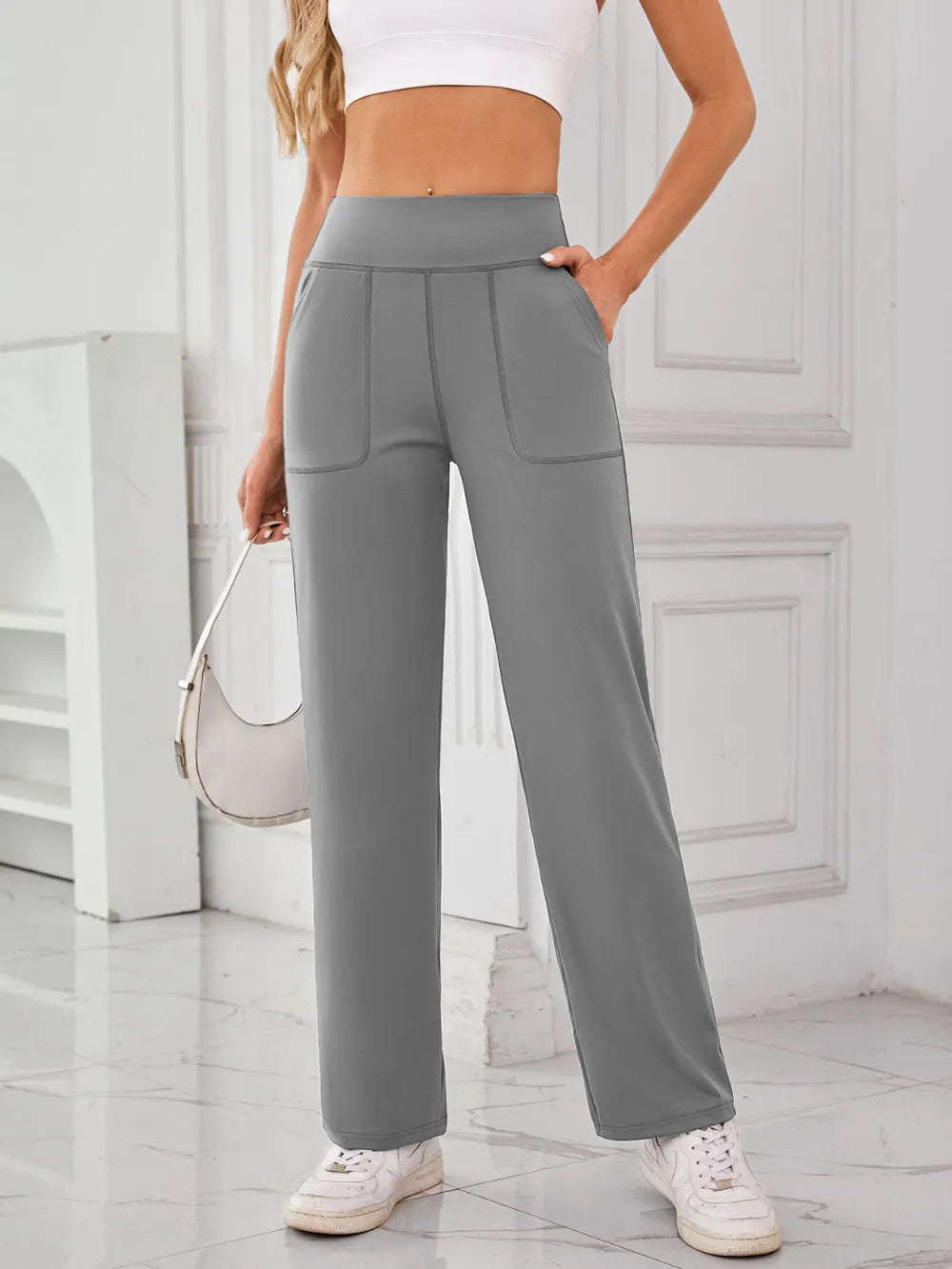 Model wearing high waist active pants with pockets