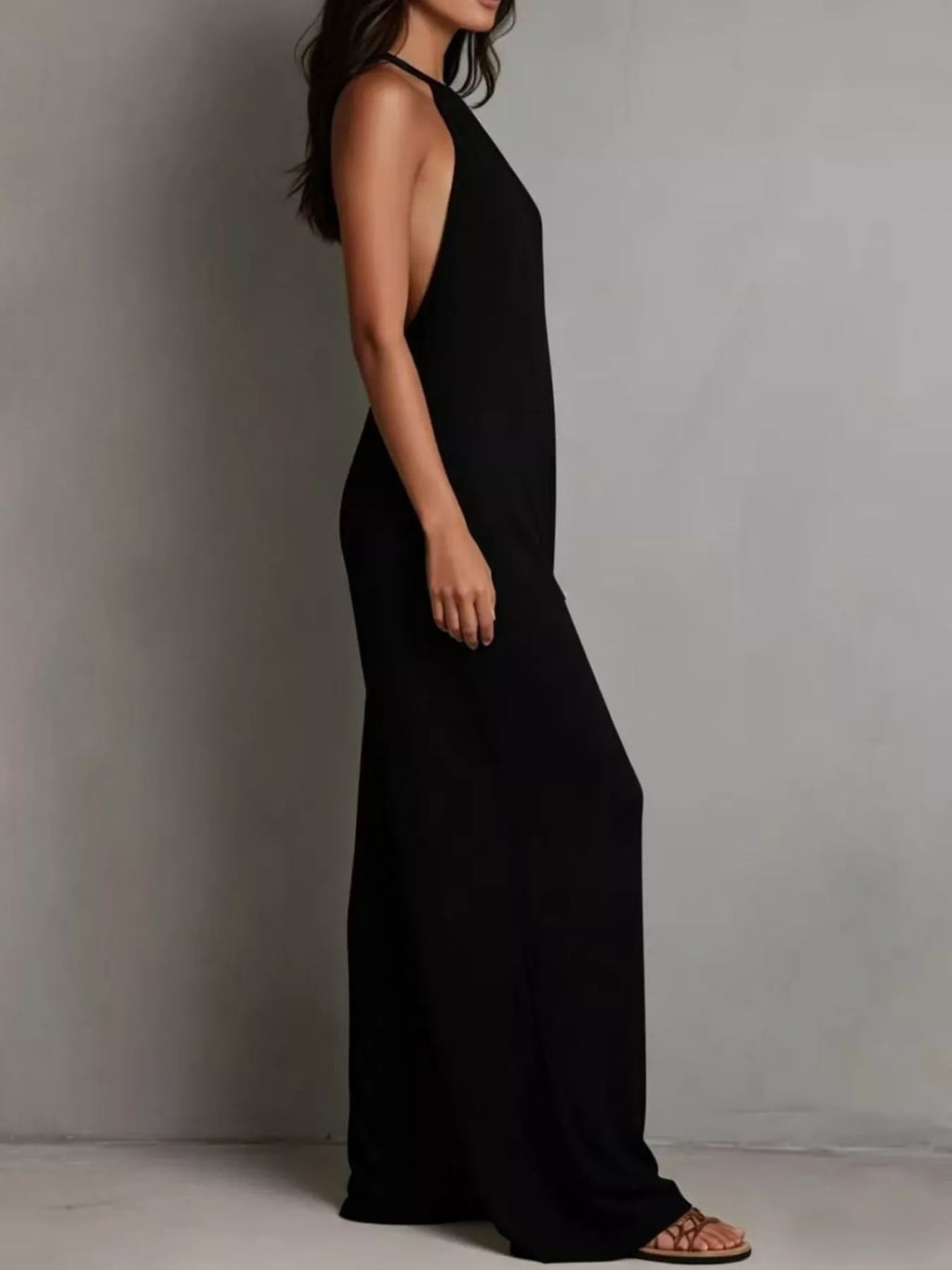 Model wearing sleeveless wide leg jumpsuit in white