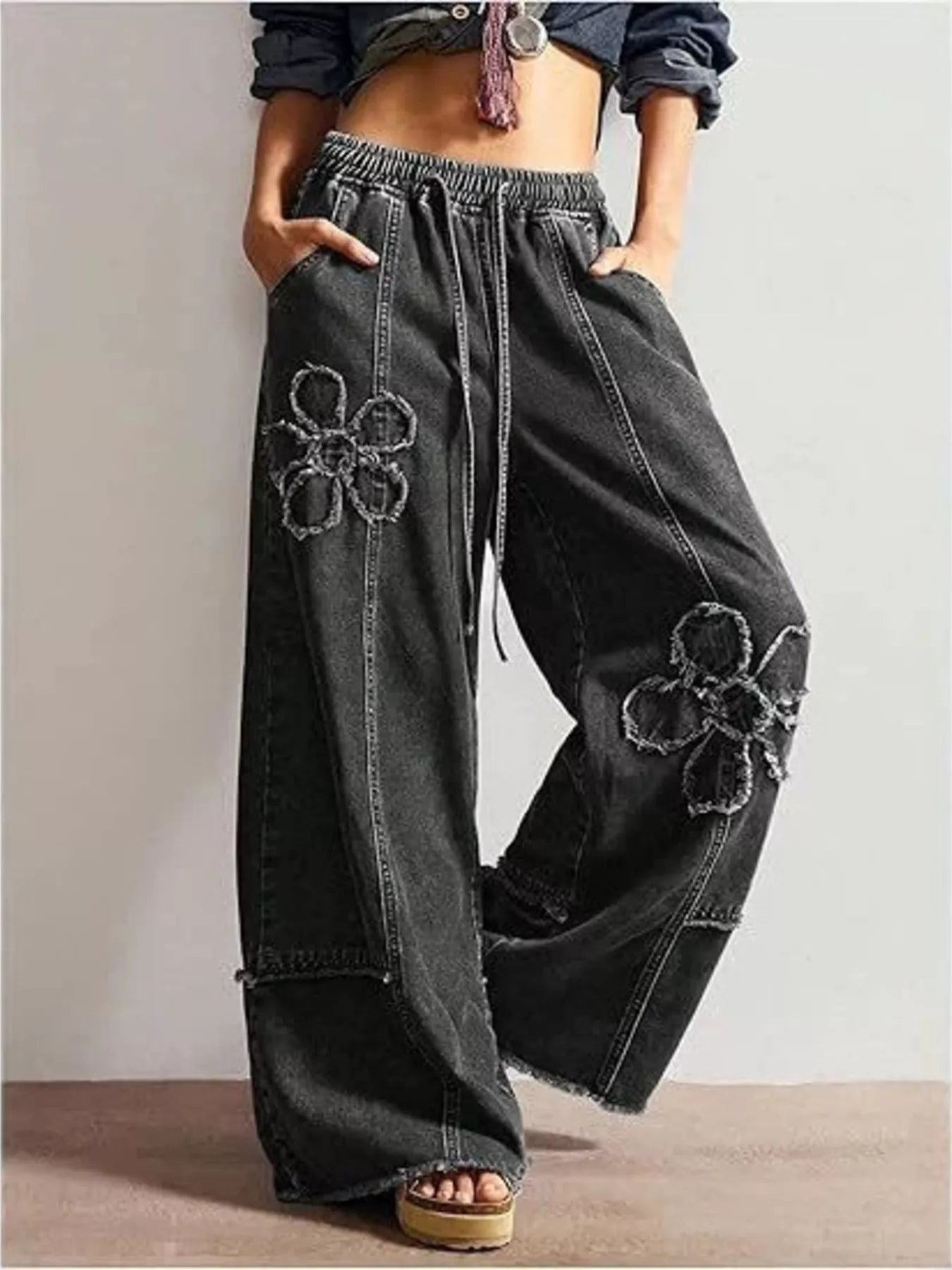 Woman wearing floral applique wide leg jeans