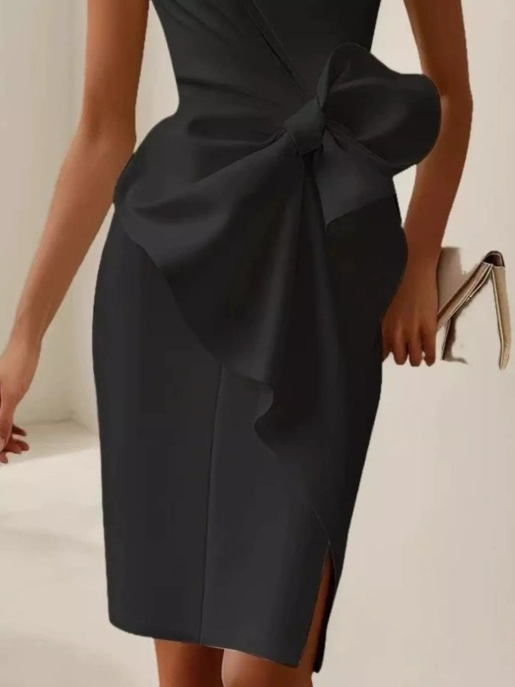 Black ruched sleeveless dress on model side view