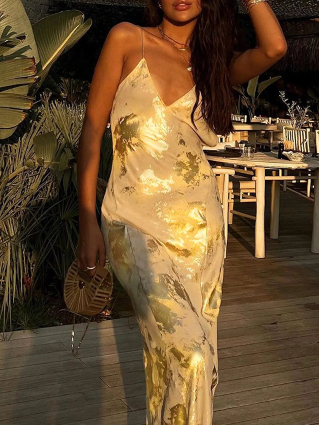 Backless detail on gold maxi dress